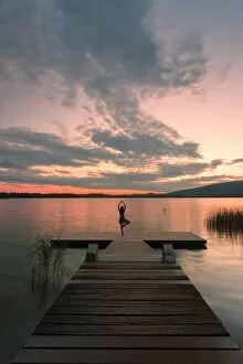 Dancers Collection: Woman dancing on a Wood pier on Pusiano lake at sunset, Bosisio Parini, Lecco province