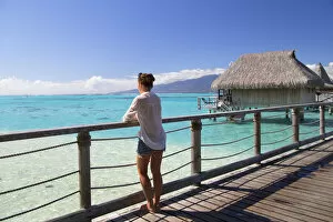 Images Dated 19th October 2015: Woman on jetty of overwater bungalows of Sofitel Hotel, Moorea, Society Islands, French