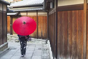 Wearing Prints: Woman in kimono walking along alleyway, Kyoto, Kansai, Japan (MR)