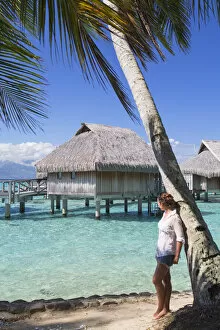 Woman looking at overwater bungalows of Sofitel Hotel, Moorea, Society Islands, French