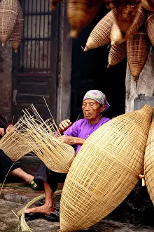 Craft Prints: Woman making traditional bamboo fish traps, Hanoi, Vietnam. (MR)