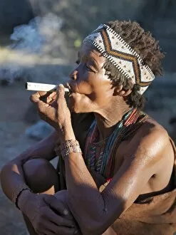 Beading Collection: A woman from the N!!S hunter-gatherer band enjoys a smoke