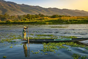Paddle Gallery: Woman paddling a boat seen from Maing Thauk Bridge (AKA Maing Thouk), Lake Inle