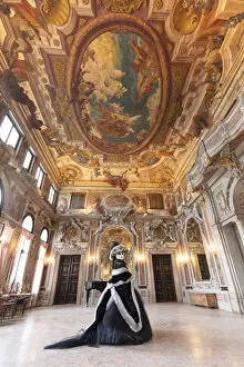 Images Dated 17th March 2020: A woman poses in costume during the Venice Carnival inside an ornate palace