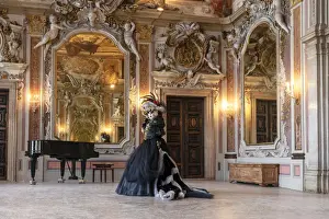 A woman poses in costume during the Venice Carnival inside an ornate palace