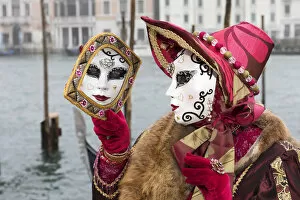 Woman in red costume and her reflecion in mirror, grand Canal, Venice, Veneto, Italy