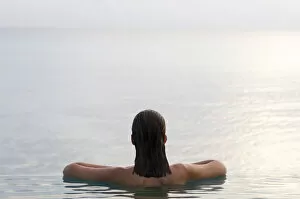 Images Dated 19th June 2020: Woman relaxing in infinity pool. Rangiroa, Tuamotu Archipelago, French Polynesia. (MR)