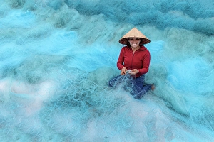 Hoi An Prints: Woman repairing fishing nets, Duy Vinh village, near Hoi An, Central Vietnam