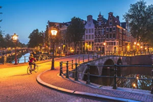 Bicylces Gallery: A woman riding a bike by night in Amsterdam along Keizersgracht canal in Amsterdam