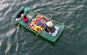 North Vietnam Prints: Woman selling snacks from her boat to tourists, Halong Bay, North Vietnam