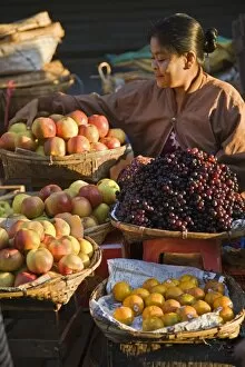 Seller Gallery: A woman sells a delicious selection of fresh fruit at Sittwes bustling market