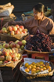 Seller Gallery: A woman sells a delicious selection of fresh fruit at Sittwes bustling market