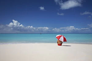 Woman Sitting on Beach with Red & White Umbrella, Barbuda, Caribbean, West Indies