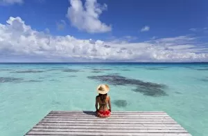 Images Dated 5th August 2015: Woman sitting on jetty, Fakarava, Tuamotu Islands, French Polynesia (MR)
