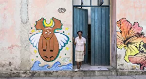Images Dated 27th May 2020: A woman standing in the doorway of her house in La Habana Vieja (Old Town), Havana, Cuba