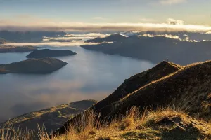 Otago Prints: Woman standing on the summit of Coromandel Peak at dawn