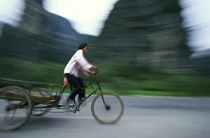 Guangxi Province Gallery: Woman on a three-wheel flatback