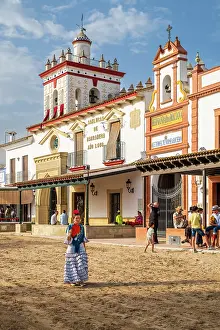 Rocio Prints: Woman traditionally dressed walking in a street during the El Rocio pilgrimage