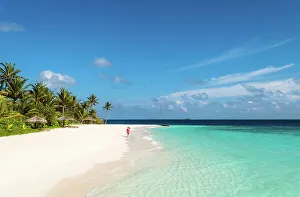 Retreat Prints: Woman walking on a sandy beach, Baa Atoll, Maldives