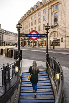Afternoon Gallery: Woman walking out the tube on to Regents Street, london, England, UK