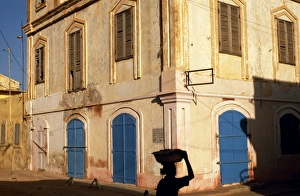 Dilapidated Prints: A woman walks along a St