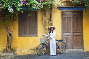 Wearing Prints: Woman wearing Ao Dai dress with bicycle, Hoi An (UNESCO World Heritage Site), Quang Ham