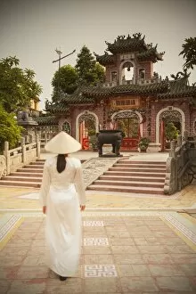 Woman wearing Ao Dai dress at Phouc Kien Assembly Hall, Hoi An (UNESCO World Heritage Site)