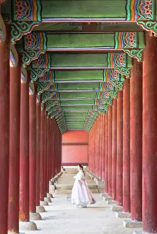 1 Person Prints: Woman wearing traditional hanbok dress passing corridor of Geunjeongjeon courtyard inside Gyeongbokgung Palace