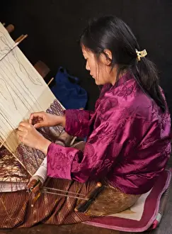 Weaver Prints: A woman weaves an intricate pattern in silk on her traditional wooden loom