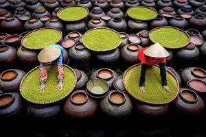Factory Prints: Women with conical hat making soy sauce in fermentation jars, Hanoi, Vietnam. (MR)