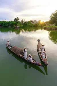 Women Prints: Women dressed in Ao Dai holding floating lanterns, Nhu Y River, Hue, Central Vietnam. (MR)