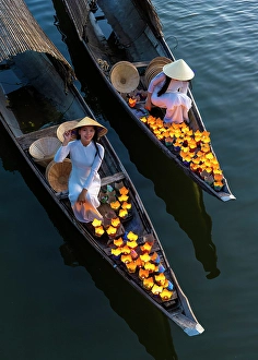 Lantern Prints: Women laying floating lanterns on the Perfume River at dusk, Hue, Central Vietnam