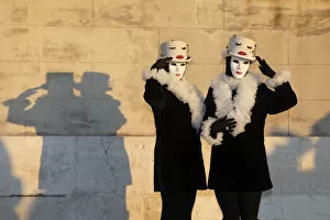 Images Dated 17th March 2020: Two women pose in identical costumes during the Venice Carnival, San Giorgio Maggiore