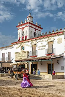 Rocio Prints: Women traditionally dressed walking in a street during the El Rocio pilgrimage