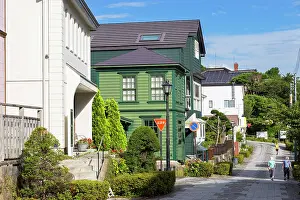 Hakodate Prints: Women walking along street with wooden houses, Motomachi, Hakodate, Hokkaido, Japan