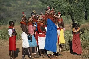 Laikipia Collection: Women watch from the side as warriors sing and dance
