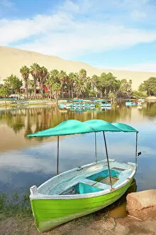 A wooden boat on the shore of the Huacachina Oasis, Ica, Peru