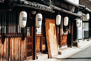 Suburbs Prints: Wooden facades and lanterns in the streets of Nara, Japan