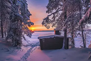 Finish Prints: A wooden hut & frozen lake near Ruka in winter landscape in finnish Lapland, Finland