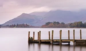 Wooden jetty on Derwent Water looking towards Skiddaw, Lake District National Park, Cumbria, England, UK. Autumn (November) 2009