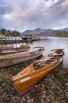 Wooden rowing boats beside Derwent Water in the Lake District, Cumbria, England. Autumn