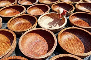 Craft Prints: Worker making bamboo basket boats, Tuy An, Phu Yen province, Vietnam. (MR)