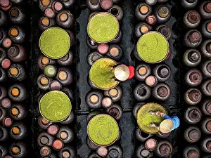 Factory Prints: Workers arranging fermented soybeans in clay jars, Hanoi, Vietnam. (MR)