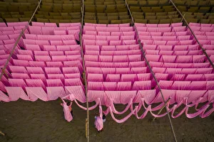 Workers hang thousands of metres of different coloured t-shirt fabrics to dry in Workers hang thousands of metres of different coloured t-shirt fabrics to dry in