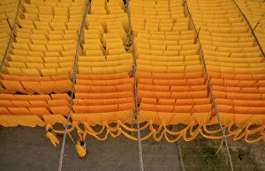 Images Dated 18th June 2021: Workers hang thousands of metres of different coloured t-shirt fabrics to dry in