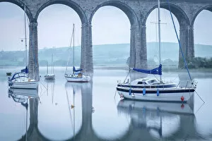 Yachts moored below the majestic viaduct at St Germans at dawn, Cornwall, England. Spring (April) 2022