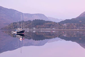 Yachts moored on a mirror still Loch Leven during twilight, Glencoe, Highland, Scotland