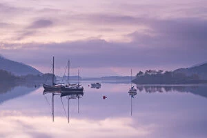 Yachts moored on a tranquil Loch Leven at twilight, Glencoe, Highland, Scotland. Autumn
