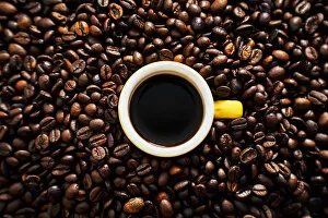 Images Dated 19th June 2017: Yellow cup of coffee with coffee beans