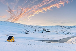 Cloudscape Prints: Yellow house on a snowy beach, Sorvaer, Soroya island, Troms og Finnmark, Northern Norway